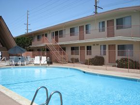 Torrance apartment for rent - A pool in front of a building with a balcony.