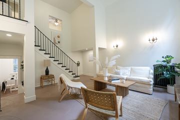 Los Angeles apartment for rent - A living room with a white couch and a wooden chair.