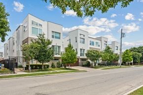 Dallas townhouse for rent - A row of modern houses with trees in front.
