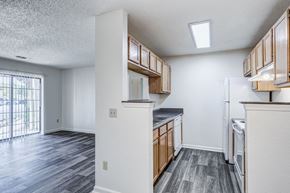 Central City apartment for rent - A kitchen with white cabinets and a refrigerator.