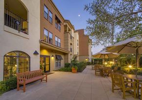 Arcadia apartment for rent - a patio with benches and tables outside of a building