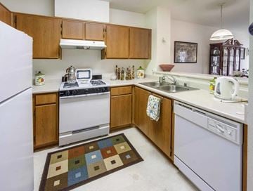 Arcadia apartment for rent - a kitchen with white appliances and wooden cabinets