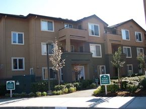 Richmond apartment for rent - an apartment building with a sidewalk in front of it
