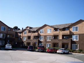 Richmond apartment for rent - an apartment building with cars parked in front of it
