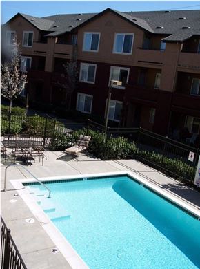 Richmond apartment for rent - a swimming pool in front of an apartment building