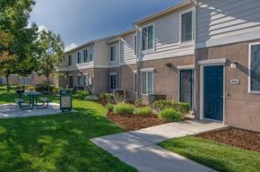 Mendota apartment for rent - A row of houses with a green sign that says 316.