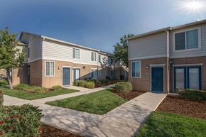 Mendota apartment for rent - A sunny day at a residential area with houses and green lawns.