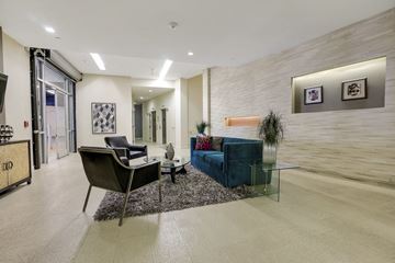 Encino apartment for rent - a living room with a couch and chairs and a glass table