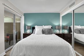Encino apartment for rent - A bedroom with a large bed and two nightstands with lamps.