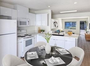 Buena Park apartment for rent - A modern kitchen with a dining table set for two.