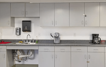 Los Angeles apartment for rent - A kitchen with white cabinets and a grey countertop.