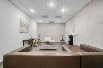 Glendale apartment for rent - A living room with a brown couch and a painting on the wall.