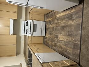 Sacramento apartment for rent - A kitchen with wooden cabinets and a stainless steel refrigerator.