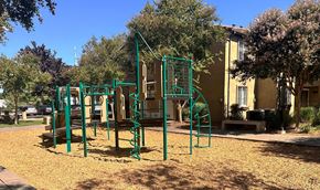 Sacramento apartment for rent - a playground in a park in front of a building