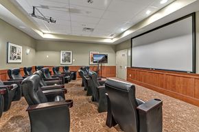 Kent apartment for rent - a large conference room with leather chairs and a projector screen