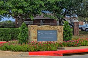 Lewisville apartment for rent - Oak Tree Village Apartments Exterior Front of Building and Sign