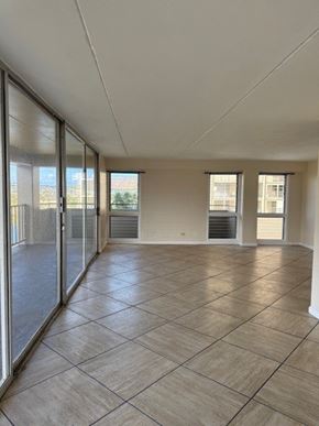 Honolulu apartment for rent - Napili Towers living room with tiled flooring and sliding glass doors.