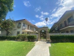 Stanton apartment for rent - an apartment building with a lawn and a sidewalk