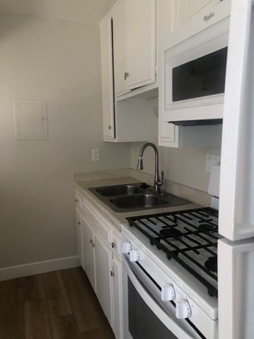 Camarillo apartment for rent - A kitchen with a white stove and microwave.