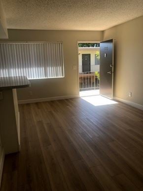 Camarillo apartment for rent - A room with wooden floors and a door leading outside.