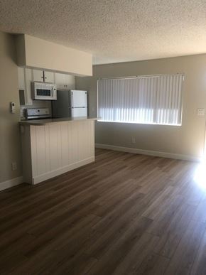 Camarillo apartment for rent - A kitchen with wood flooring and a window with blinds.