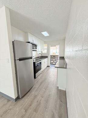 Waipahu apartment for rent - A kitchen with a refrigerator, oven, and cabinets.