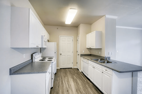 Englewood apartment for rent - A kitchen with white cabinets and a white stove top oven.