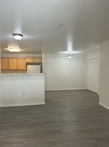 Nipomo apartment for rent - A kitchen with white cabinets and a white fridge with a countertop.