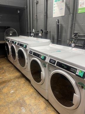 Redondo Beach apartment for rent - Seaview laundry room with a row of washing machines .