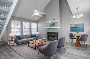Carrollton apartment for rent - A living room with a grey couch, a coffee table, and a fireplace.