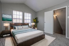 Carrollton apartment for rent - A bedroom with a large bed and a painting on the wall.