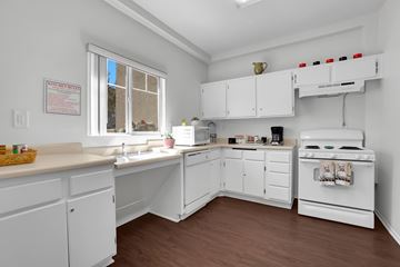 Simi Valley apartment for rent - A kitchen with white cabinets and a stove top oven.