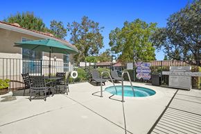 Simi Valley apartment for rent - A patio with a table and chairs and a pool.