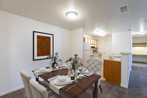 Brighton apartment for rent - A dining room with a wooden table set for a meal.