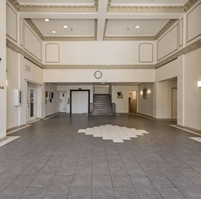 Los Angeles apartment for rent - a large room with a clock on the wall and a staircase