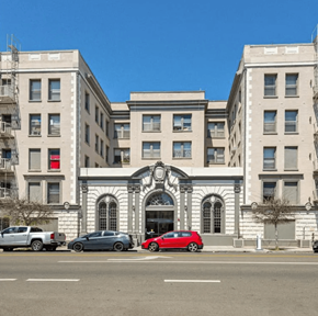 Los Angeles apartment for rent - a large building with cars parked in front of it on a city street