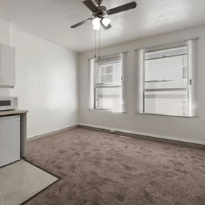 Los Angeles apartment for rent - an empty room with two windows and a ceiling fan