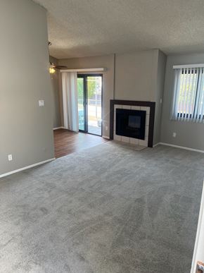 Los Angeles apartment for rent - A living room with a fireplace and sliding glass doors.