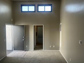 Los Angeles apartment for rent - A room with a carpeted floor, two doors, and two windows.