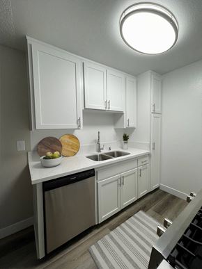Mission Hills apartment for rent - a small kitchen with white cabinets and a sink