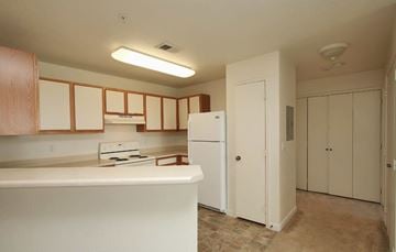 Englewood apartment for rent - A kitchen with white appliances and wooden cabinets.