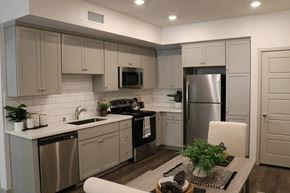 Camarillo apartment for rent - a kitchen with white cabinets and stainless steel appliances