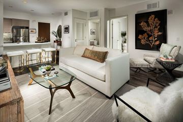 Santa Monica apartment for rent - A modern living room with a white couch and a glass coffee table.