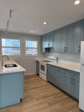 Honolulu apartment for rent - Pacific Oasis kitchen with a white counter top and blue cabinets.