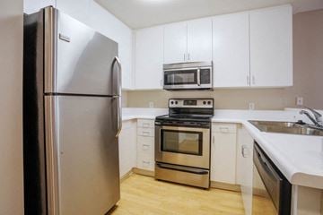 Santa Monica apartment for rent - a kitchen with stainless steel appliances and white cabinets