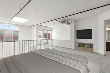 Los Angeles apartment for rent - A modern living room with a grey carpet and a black television.