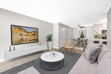 Torrance apartment for rent - A living room with a grey couch, a white coffee table, and a painting on the wall.