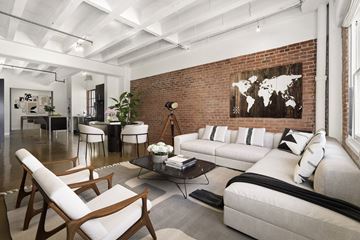 Los Angeles apartment for rent - A living room with a white couch and a world map on the wall.