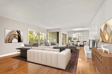 Pasadena apartment for rent - A modern living room with a white sofa and a wooden floor.