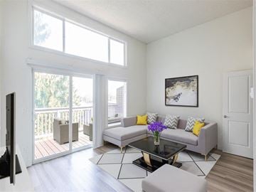 West Linn apartment for rent - A living room with a grey couch, a coffee table, and a painting on the wall.